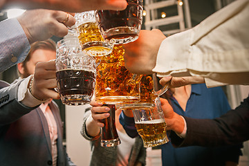 Image showing Group of friends enjoying evening drinks with beer