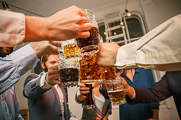 Image showing Group of friends enjoying evening drinks with beer