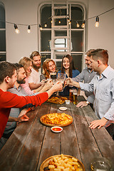 Image showing Group of friends enjoying evening drinks with beer