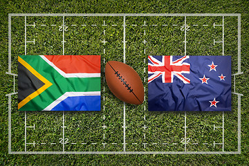 Image showing South Africa vs. New Zealand flags on rugby field