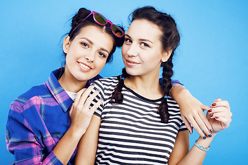 Image showing best friends teenage school girls together having fun, posing emotional on blue background, besties happy smiling, lifestyle people concept 