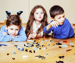 Image showing funny cute children playing lego at home, boys and girl smiling, first education role lifestyle