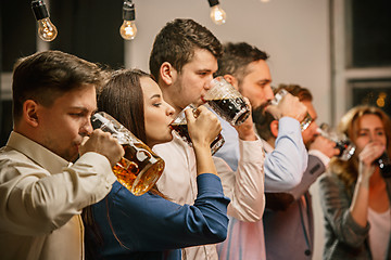 Image showing Group of friends enjoying evening drinks with beer