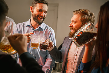 Image showing Group of friends enjoying evening drinks with beer