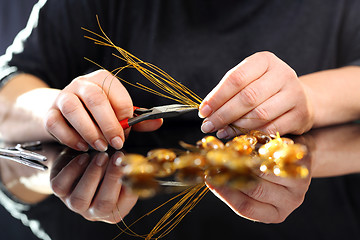 Image showing Create an amber necklace in a jewelery workshop