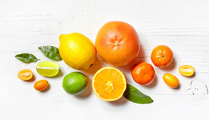 Image showing various citrus fruits on white wooden table