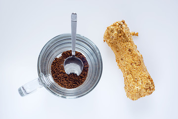 Image showing Instant coffee and eclair, top view