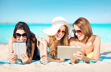 Image showing happy young women with tablet pc on summer beach