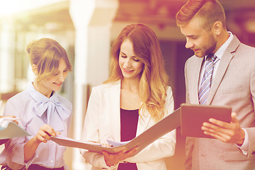 Image showing business team with tablet pc and folders at office