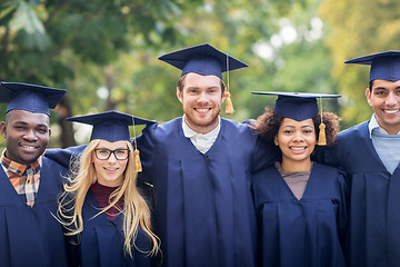 Image showing happy students or bachelors in mortar boards