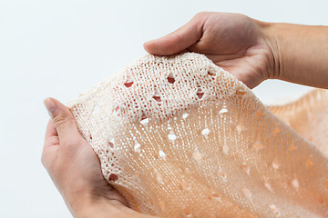 Image showing close up of hands with knitted clothing item