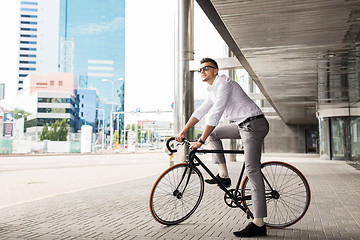 Image showing man with bicycle and headphones on city street