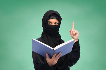 Image showing muslim woman in hijab with book over white