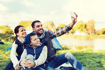 Image showing family with smartphone taking selfie at campsite