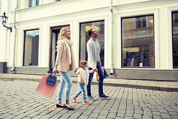 Image showing happy family with child and shopping bags in city