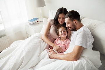 Image showing happy family in bed at home