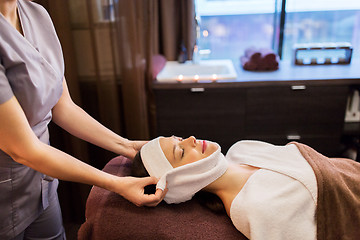 Image showing woman having face massage with towel at spa parlor