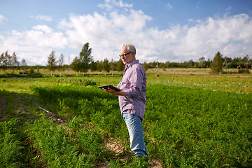 Image showing senior man with tablet pc computer at county