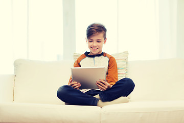 Image showing smiling boy with tablet computer at home