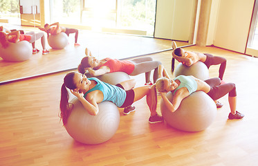 Image showing group of women exercising with fit balls in gym