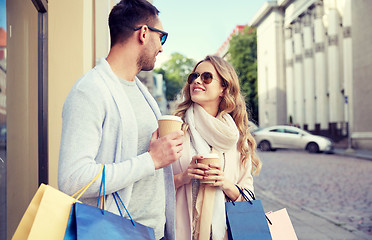 Image showing happy couple with shopping bags and coffee in city