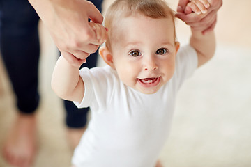 Image showing happy baby learning to walk with mother help