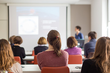 Image showing Woman giving presentation in lecture hall at university.