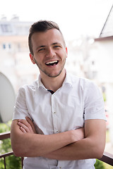 Image showing man standing at balcony