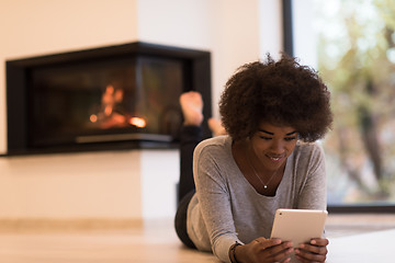 Image showing black women used tablet computer on the floor