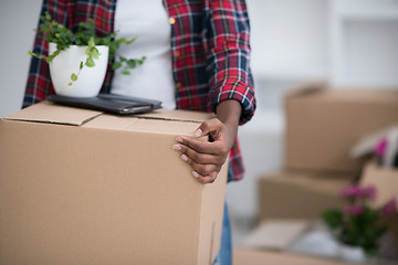 Image showing Black girl moving in the new apartment