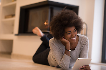 Image showing black women used tablet computer on the floor