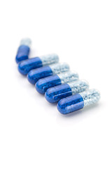 Image showing Blue capsules and pills background