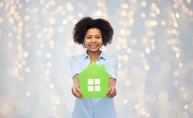 Image showing happy african american woman with green house icon