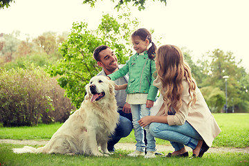 Image showing happy family with labrador retriever dog in park