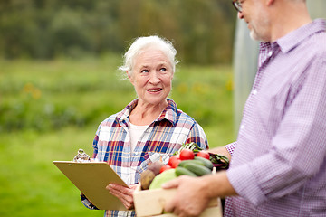 Image showing senior couple with box of vegetables on farm