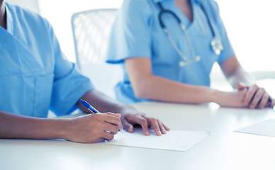 Image showing close up of doctor taking notes at hospital