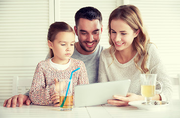 Image showing happy family with tablet pc at restaurant