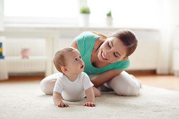 Image showing happy mother playing with baby at home