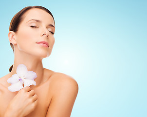 Image showing beautiful young woman with orchid flower