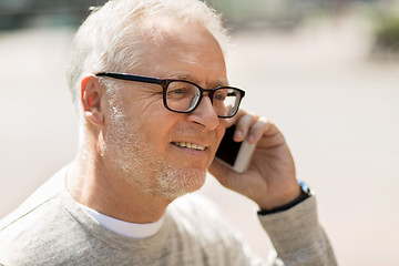 Image showing happy senior man calling on smartphone in city