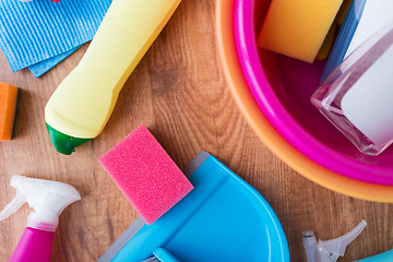 Image showing basin with cleaning stuff on wooden floor