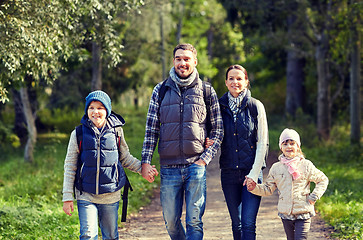 Image showing happy family with backpacks hiking