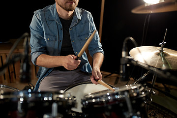 Image showing male musician playing drums and cymbals at concert