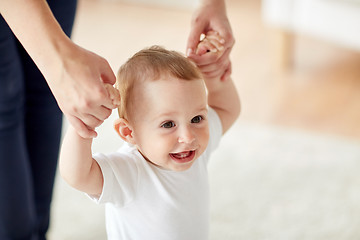 Image showing happy baby learning to walk with mother help