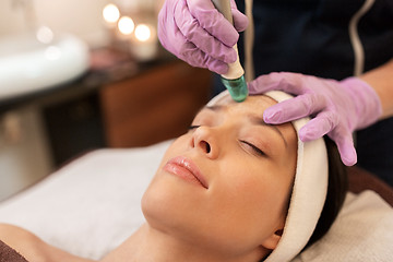 Image showing woman having microdermabrasion facial treatment