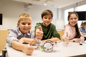 Image showing happy children building robots at robotics school