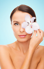 Image showing beautiful young woman with orchid flower