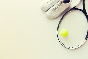 Image showing close up of tennis racket with ball and sneakers