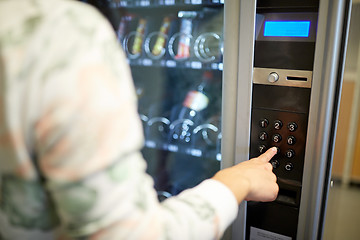 Image showing hand pushing button on vending machine keyboard