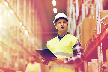 Image showing man with clipboard in safety vest at warehouse